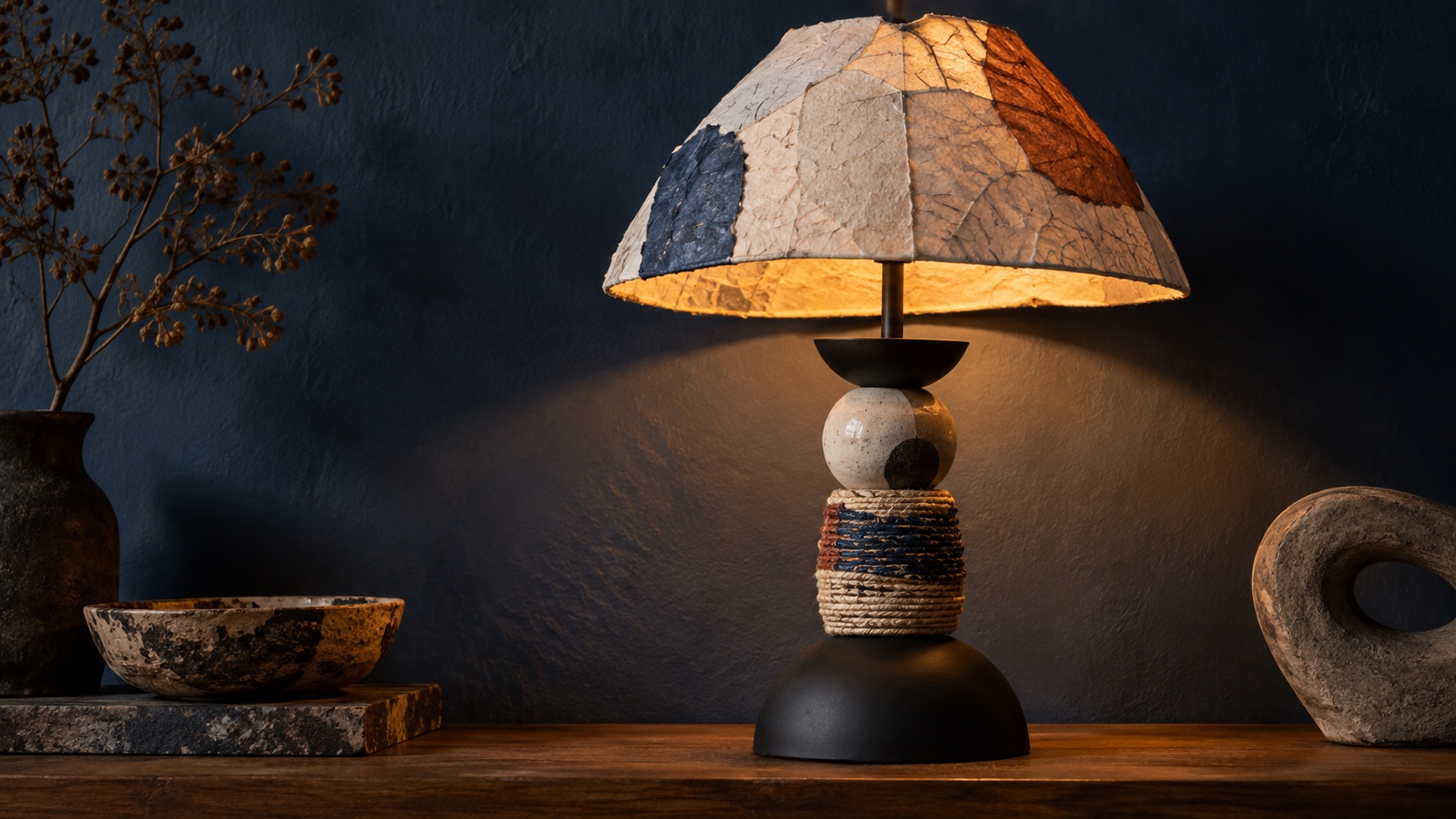 A sculptural mixed-media lamp combining painted surfaces and assembled materials.